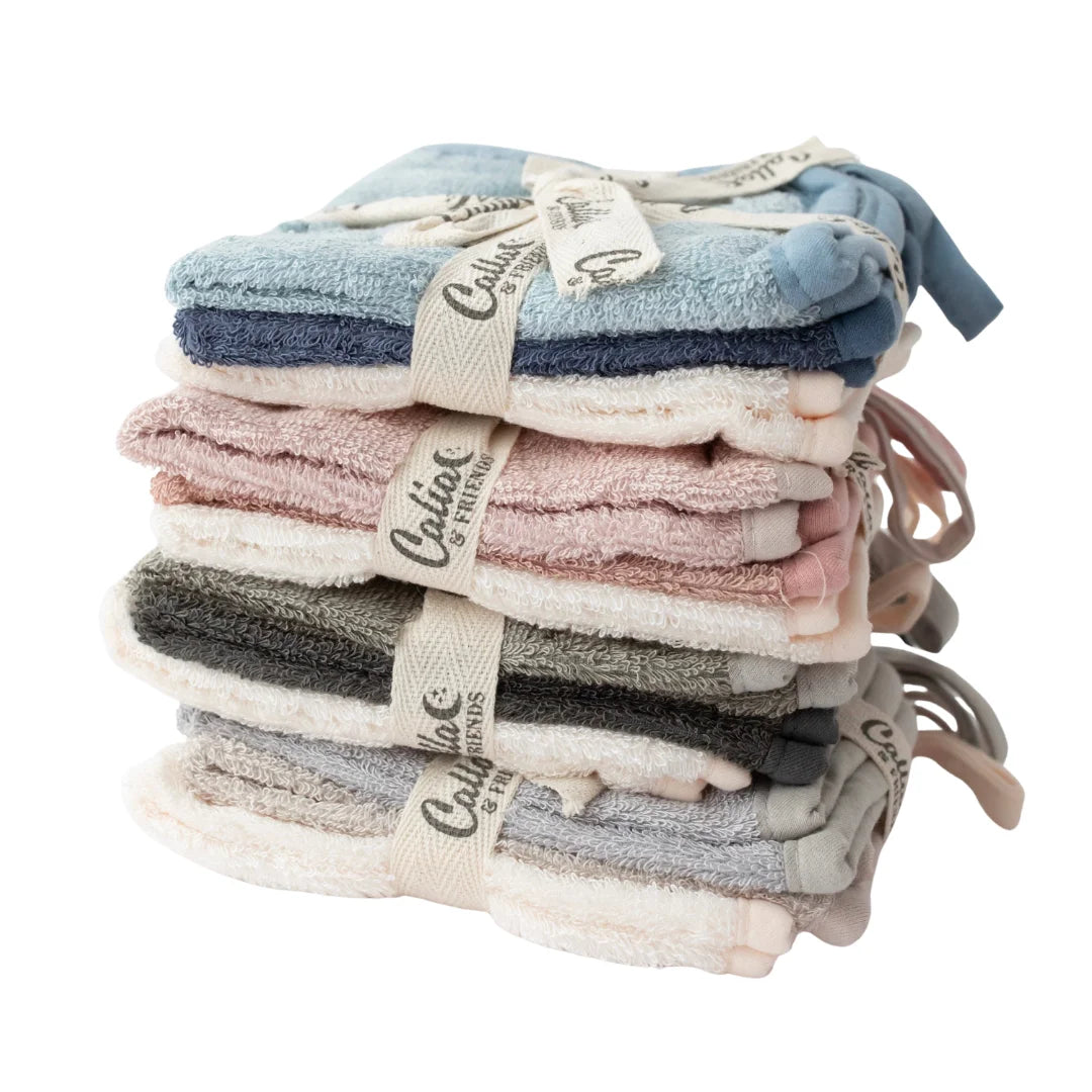 Stack of folded towels with Calter branding on a white background
