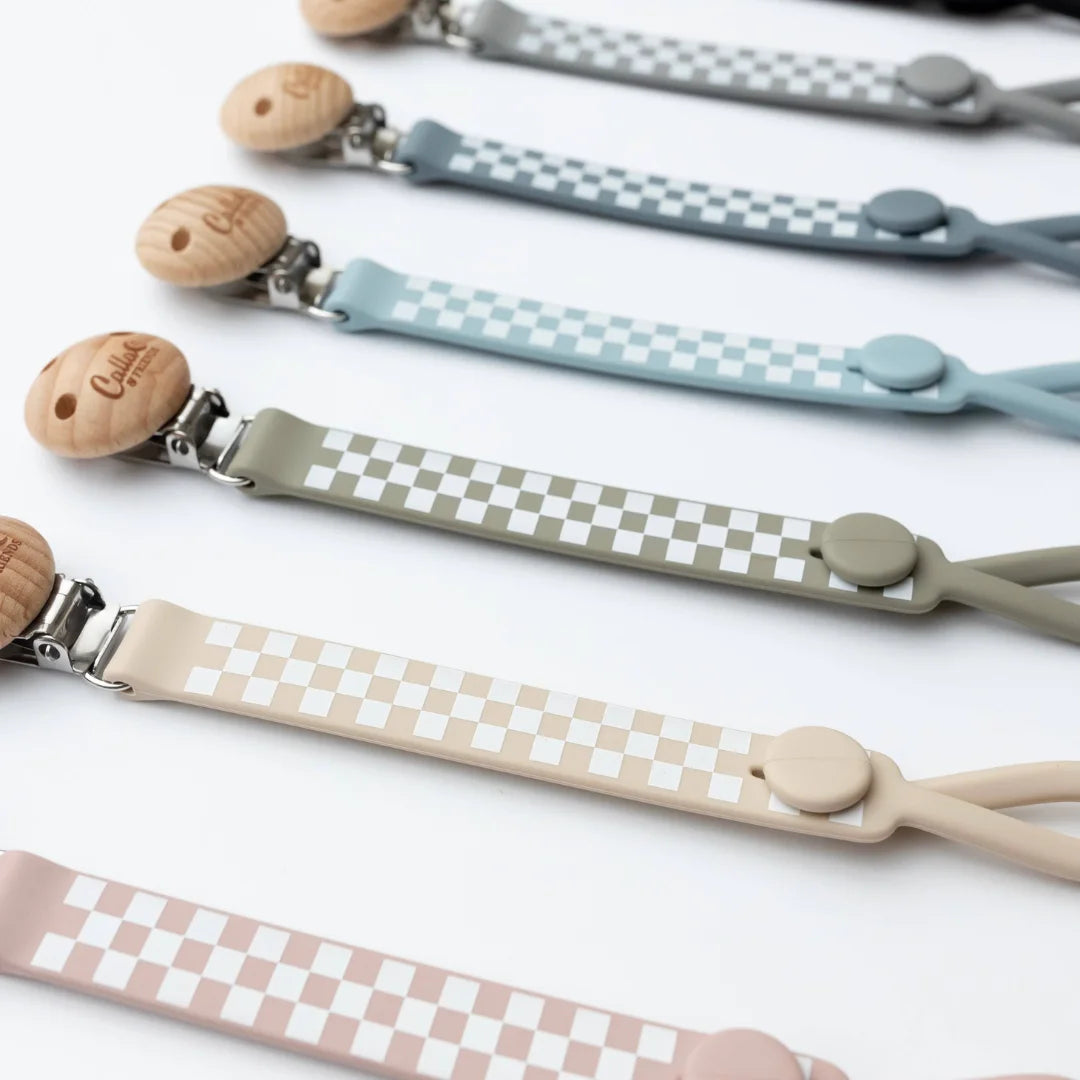 Set of pacifier clips with checkered patterns on a white background