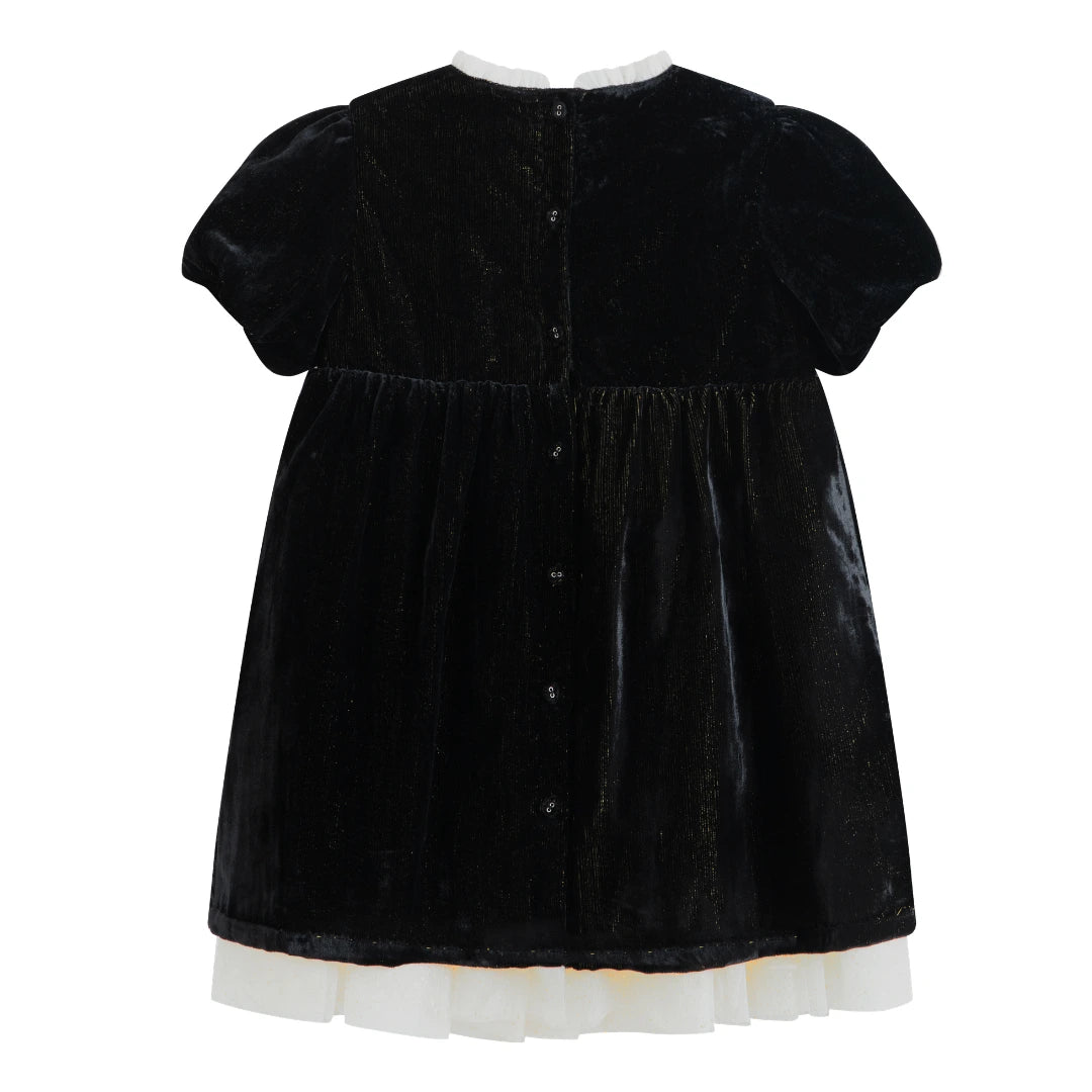 Black velvet dress with white trim on a white background