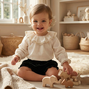 Child playing with wooden toys in a cozy room with baskets and shelves.
