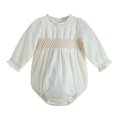 White baby romper with lace details on a white background
