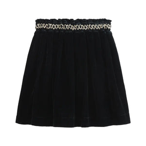 Black skirt with a decorative waistband on a white background