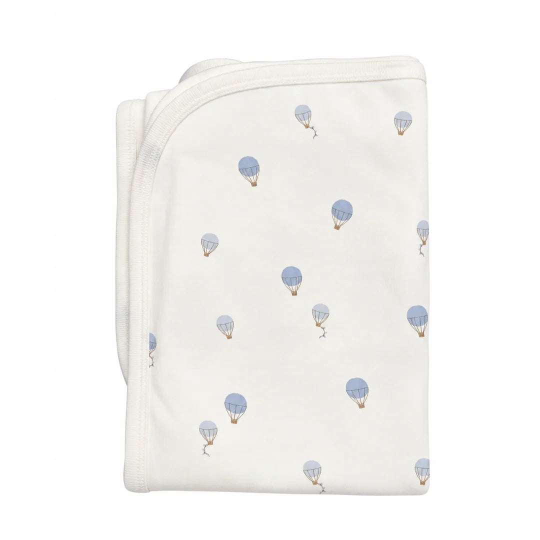 A flat-lay view of the Coton Pompom dreamy air balloons blanket in ivory.