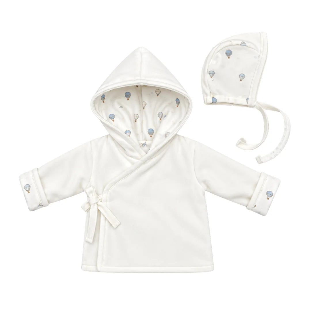 A flat-lay view of the Coton Pompom dreamy air balloons jacket and bonnet set in ivory.