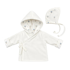 A flat-lay view of the Coton Pompom dreamy air balloons jacket and bonnet set in ivory.