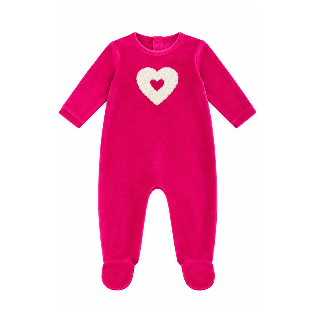 A flat-lay view of the Coton Pompom embrace heart footie in fuchsia and ivory.