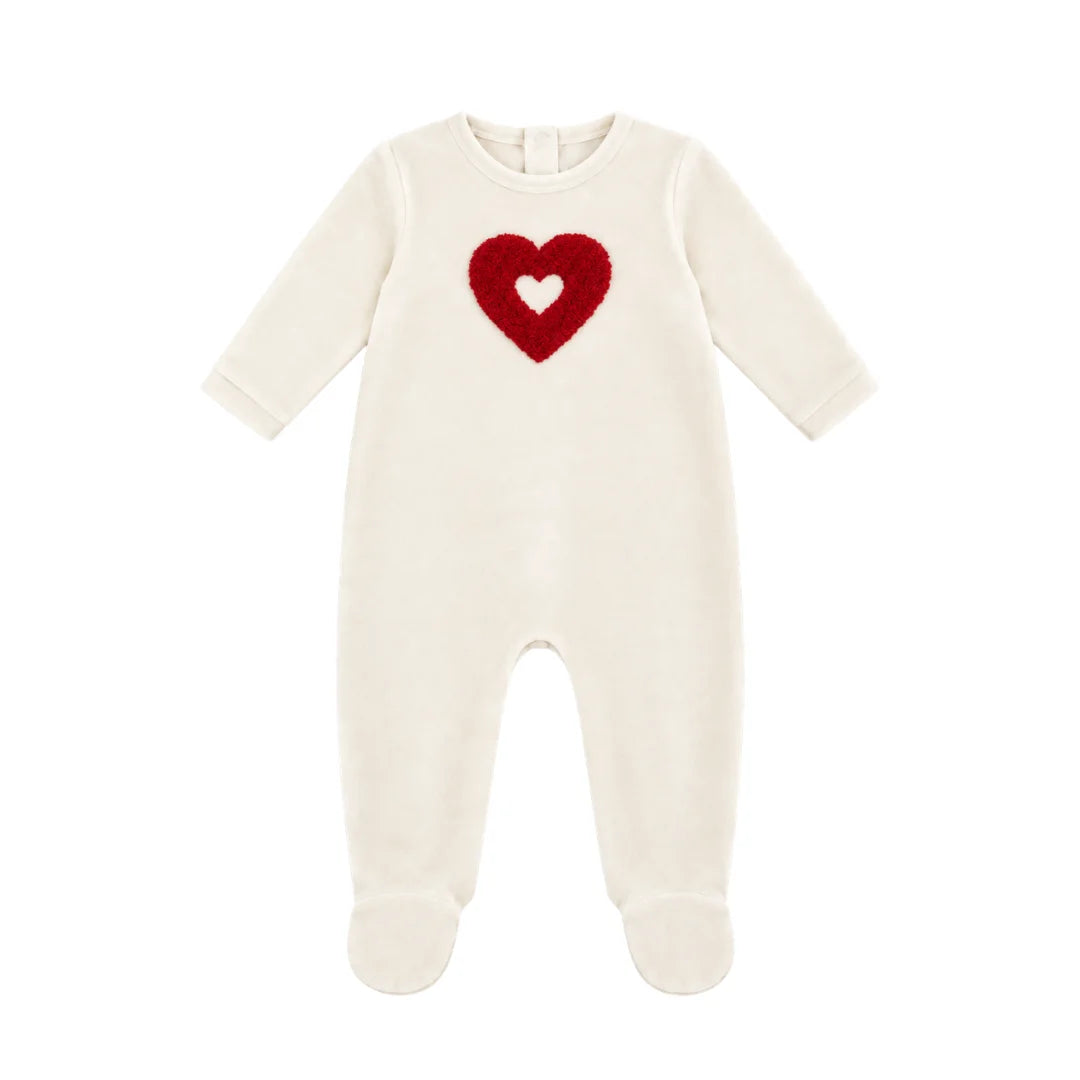 A flat-lay view of the Coton Pompom embrace heart footie in ivory and red.