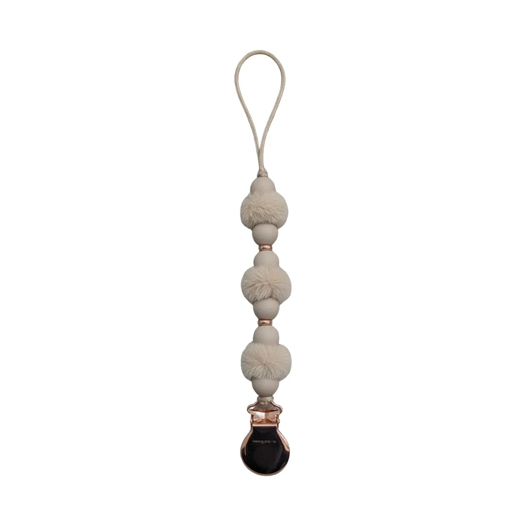 front view of the Crystal Dream pom pacifier clip in beige.