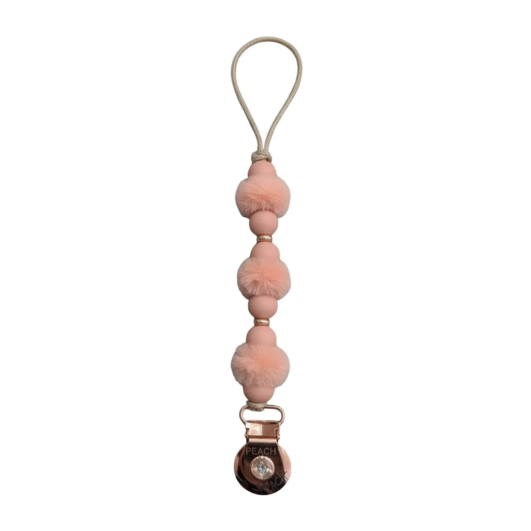 front view of the Crystal Dream pom pacifier clip in mauve.