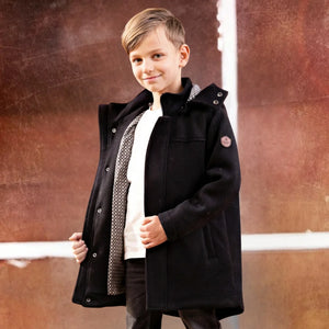 A child wearing the Denali black wool coat comfortably