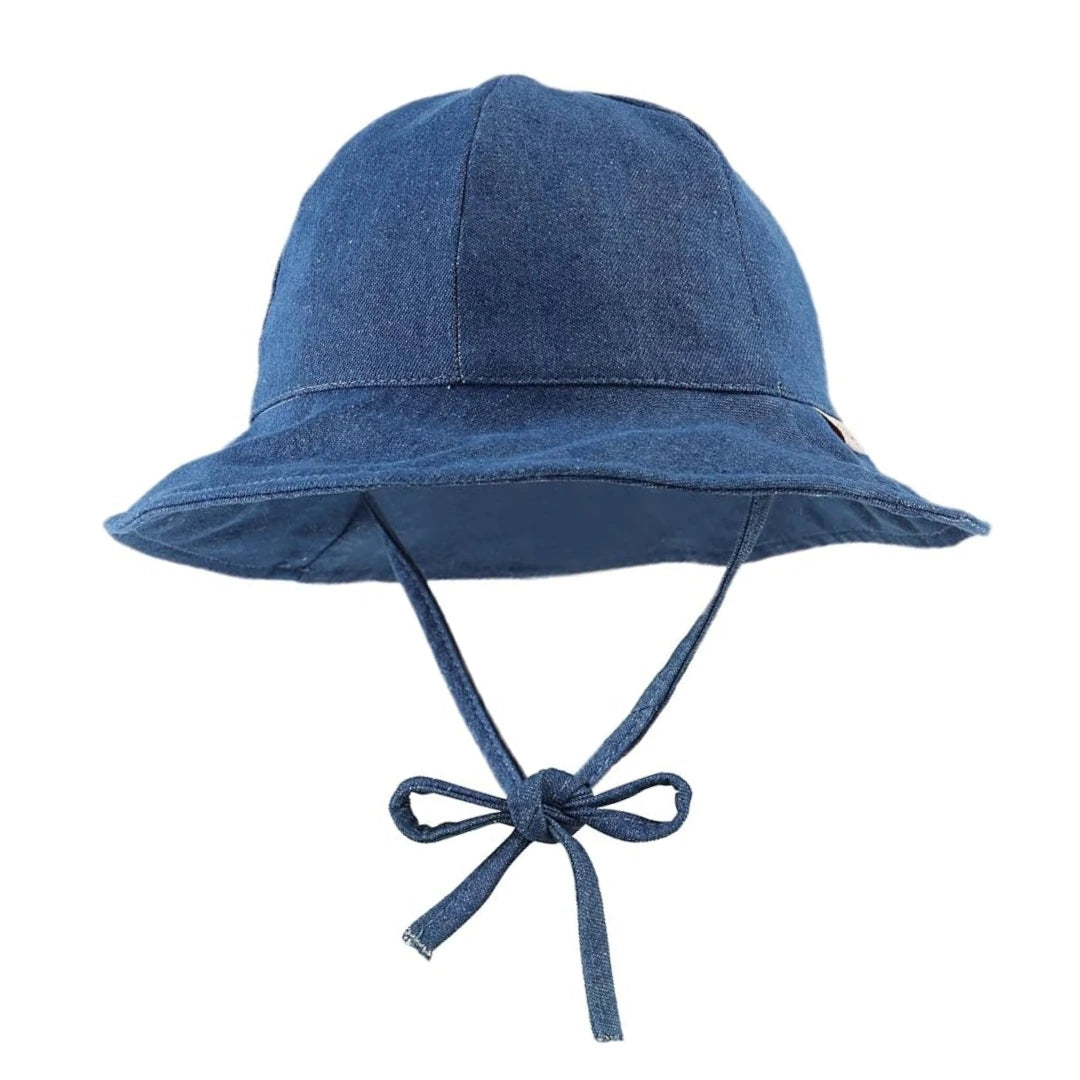 A breathtaking Denim Floppy Sunhat for babies, showcasing its authoritative wide brim and premium washed indigo cotton texture.