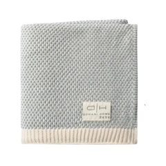 A three-piece baby bedding set featuring a footed sleeper, a beanie, and a blanket, all with matching light pink and white horizontal stripes, laid out on a solid white background.