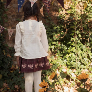 The clean back view of the luxury children's tailored blouse.