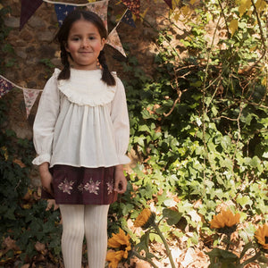 child styled in the Early Sunday Lauren ecru blouse during an outing.