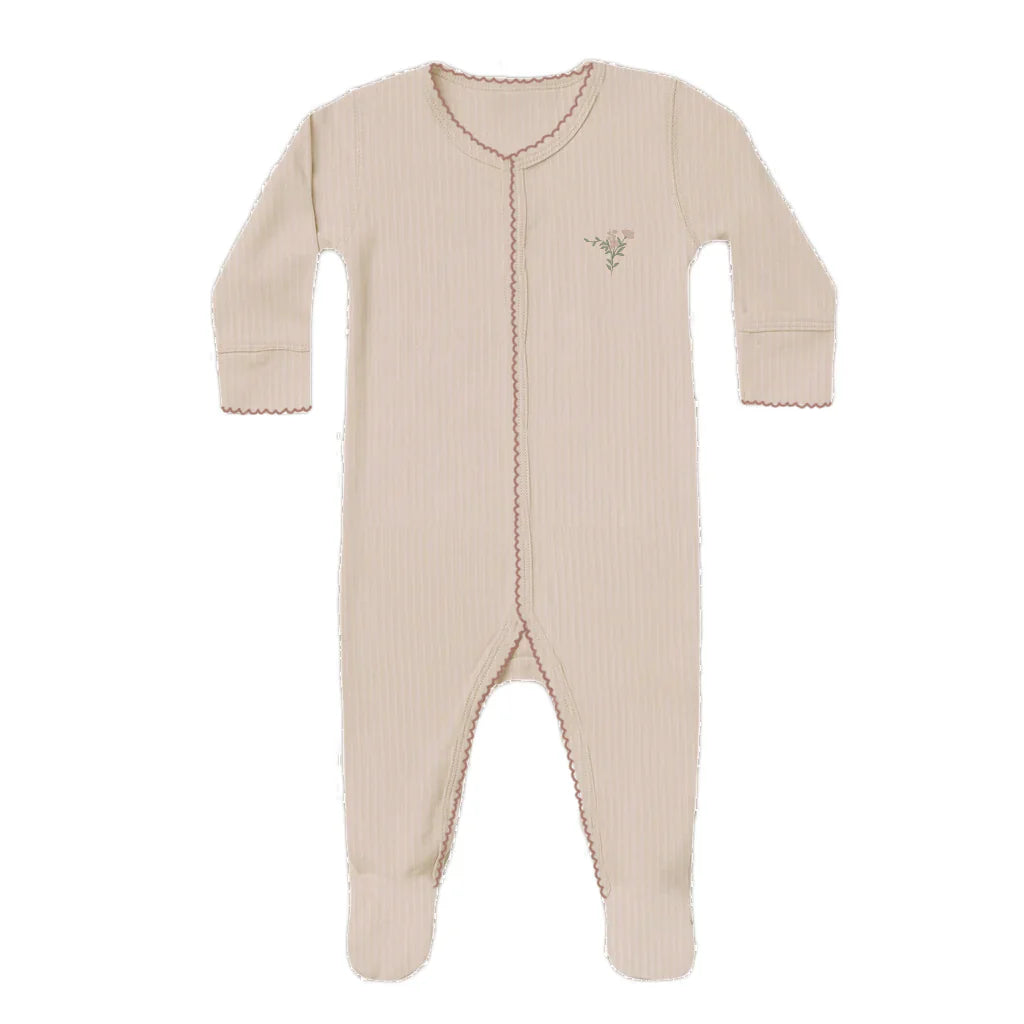 Beige baby onesie with a small design on a white background