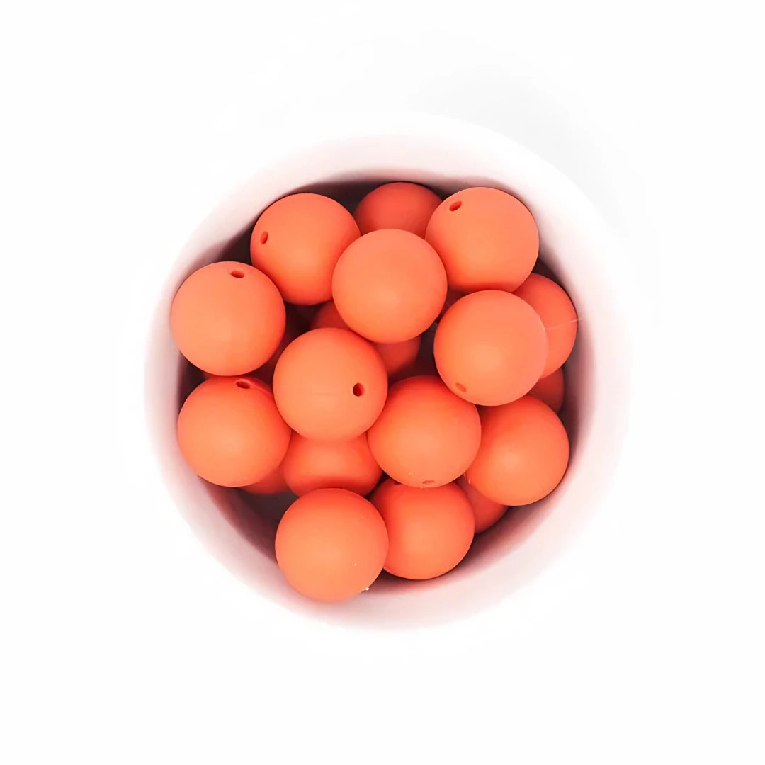 A breathtaking Limited Edition EMO & CO. Saylor Petite Pacifier Clip in vibrant Coral, highlighting its architectural silicone beads and polished clip.