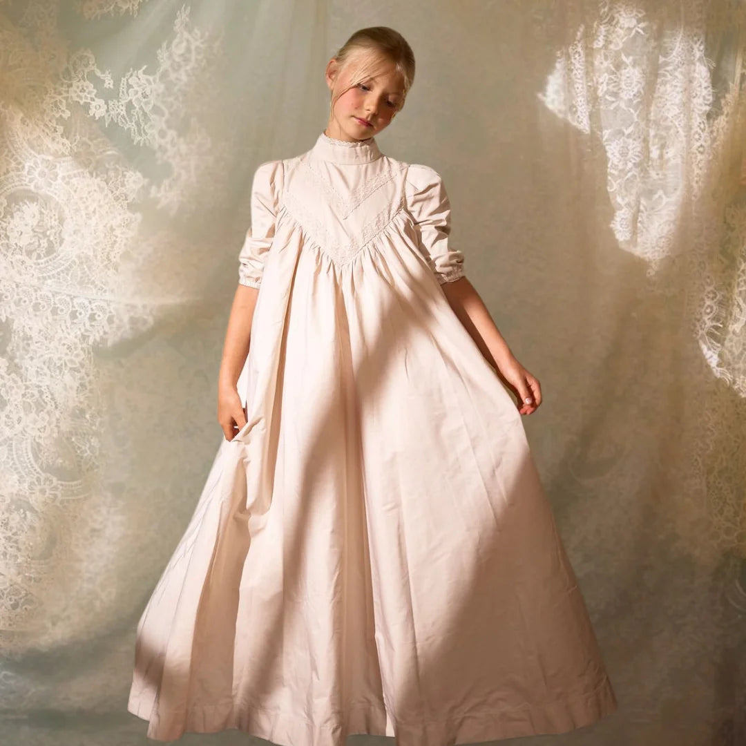 A child wearing the Francesca Guiliano formal gown gracefully during a celebration.