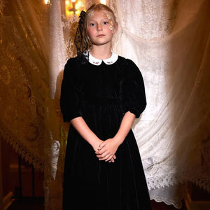 A child wearing the Francesca Guiliano formal gown gracefully during a celebration.