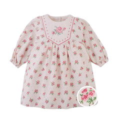 A front view of the Gingersnaps baby pink dress featuring a floral print and detailed embroidery on the yoke.