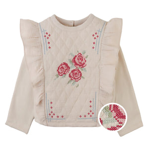 A front view of the beige Gingersnaps Rosamund top with delicate floral cross-stitch embroidery.