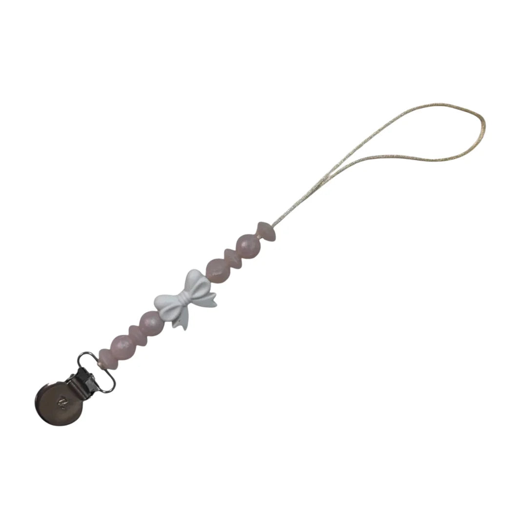 A sophisticated Three Hearts & Co. Coquette Bow Pacifier Clip in a soft neutral cotton finish, showcasing the architectural bow and premium clip detail.
