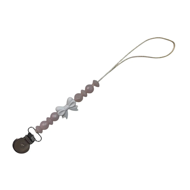 A sophisticated Three Hearts & Co. Coquette Bow Pacifier Clip in a soft neutral cotton finish, showcasing the architectural bow and premium clip detail.