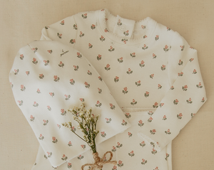 Floral-patterned fabric with a small bouquet of flowers on a beige background