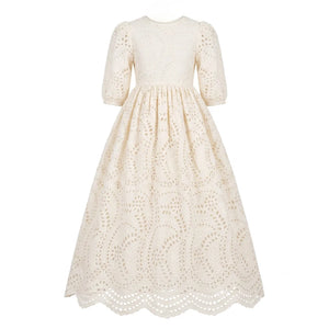 A breathtaking Jouet Broderie Gown in white, showcasing intricate eyelet embroidery and a sophisticated architectural silhouette for siblings