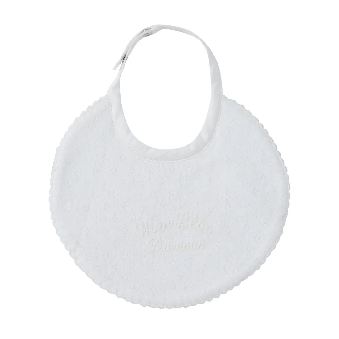 A front view of the Kipp white mon bebe baby feeding bib.