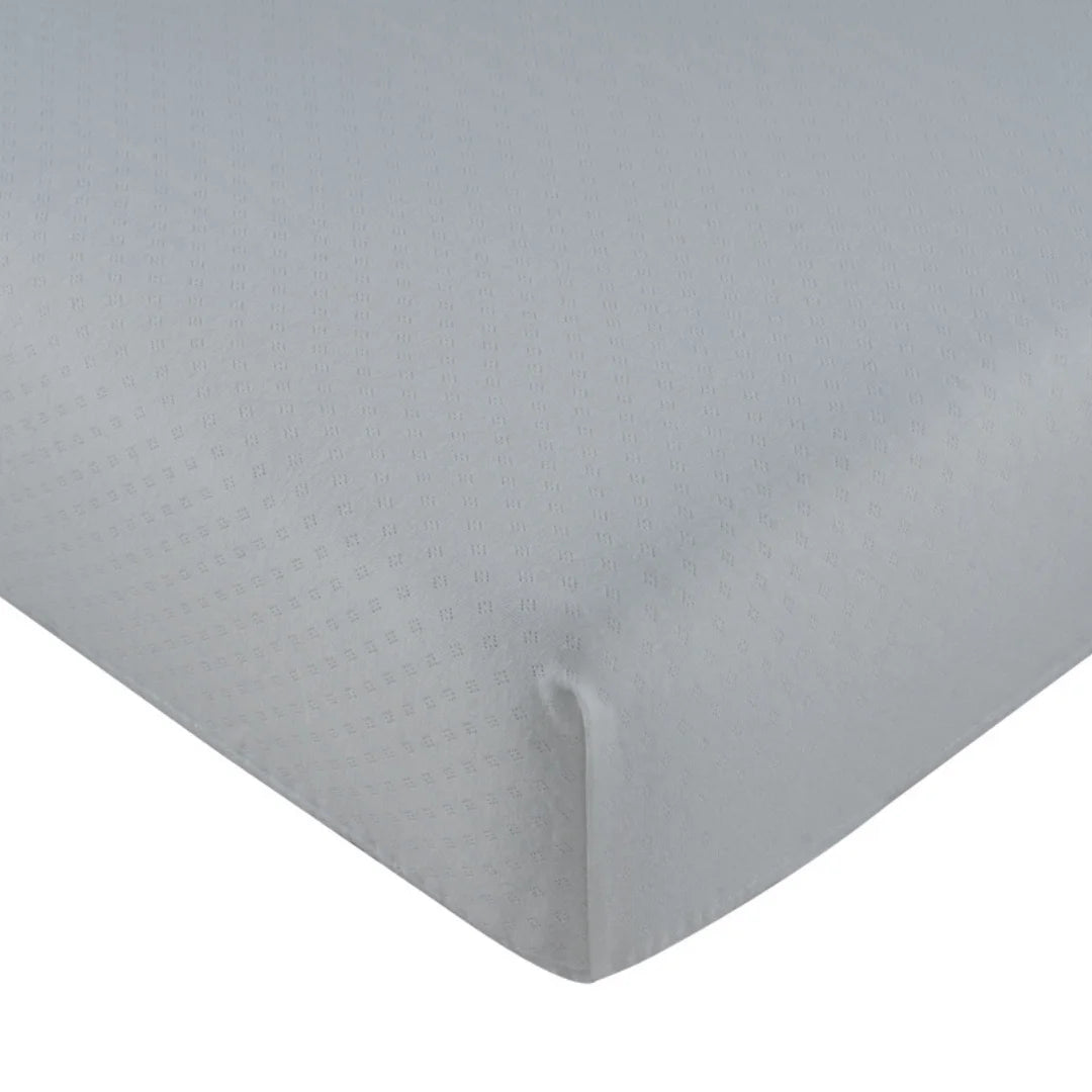 A front view of the Kipp white mon bebe mini 4-piece crib bedding set.