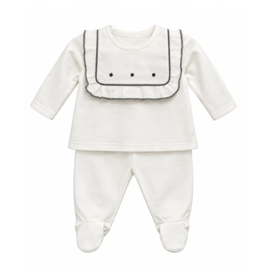 A flat-lay view of the La Mascot baby set with linen embroidered yoke.