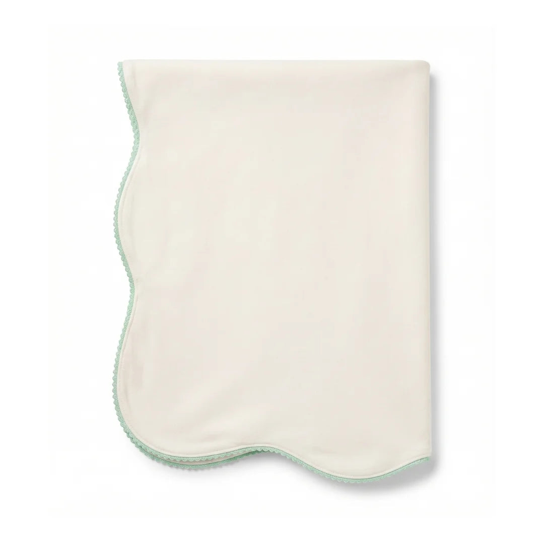 A flat-lay view of the La Mascot picot trim blanket in white and green.