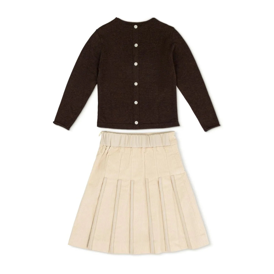 A front view of the La Nina cream corduroy skirt and logo sweater baby set.