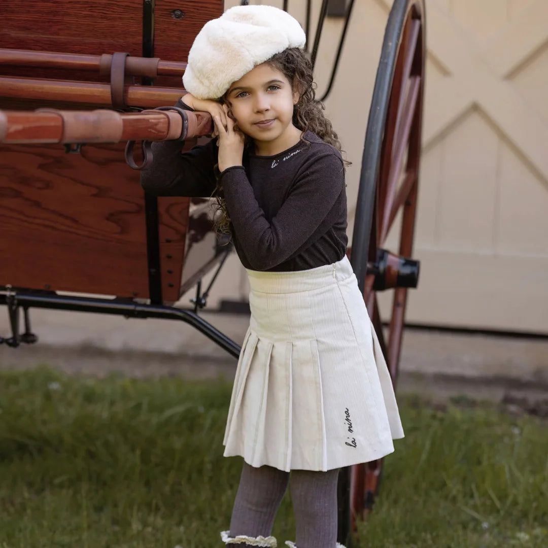 A toddler wearing the La Nina cream set