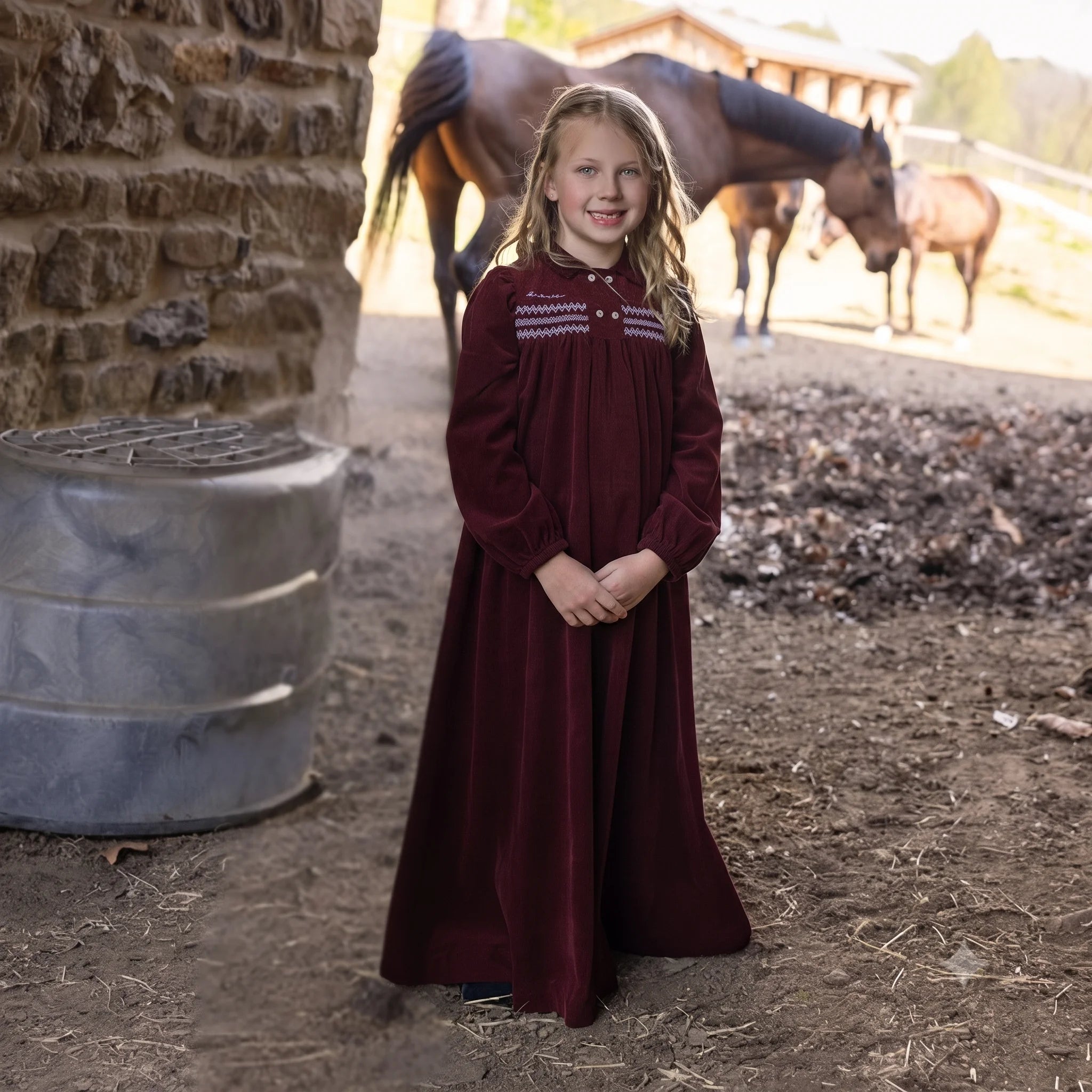 A front view of the La Nina burgundy corduroy smocked maxi holiday dress.