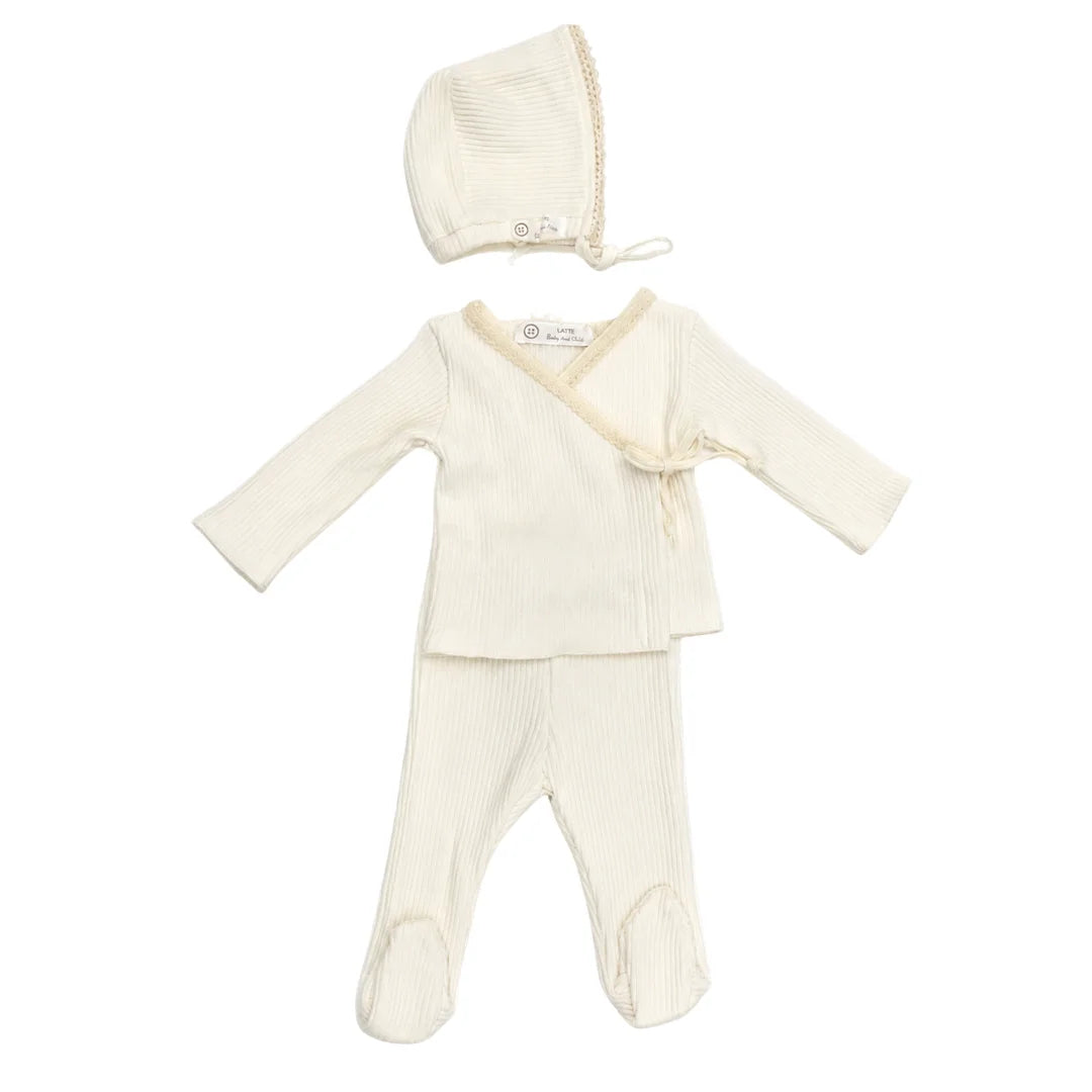 A front view of the elegant white Latte Rib Lace Knit set with matching bonnet.