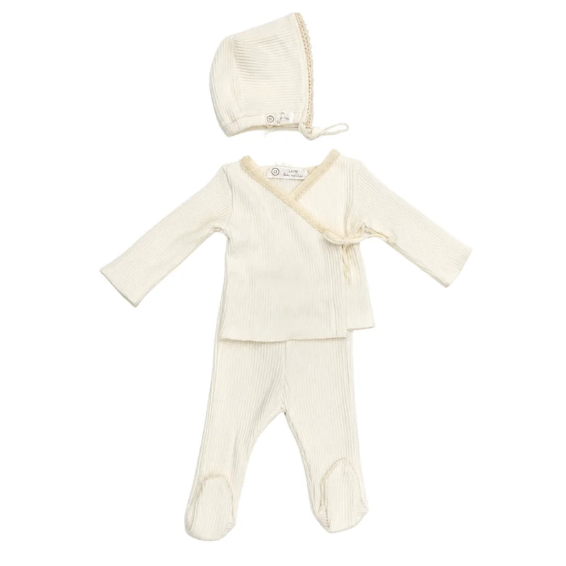 A front view of the elegant white Latte Rib Lace Knit set with matching bonnet.