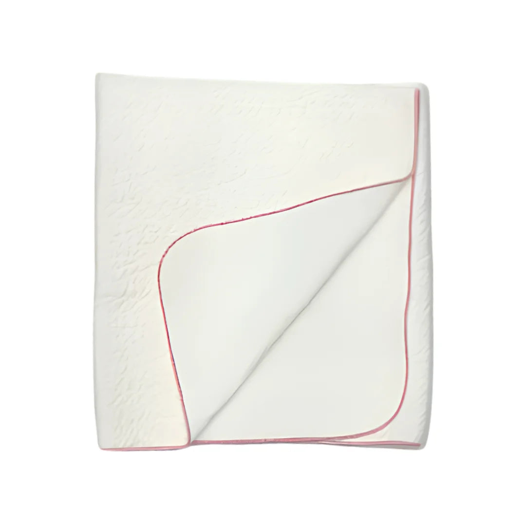 A front view of the Latte jacquard blanket in white with a mauve edge.