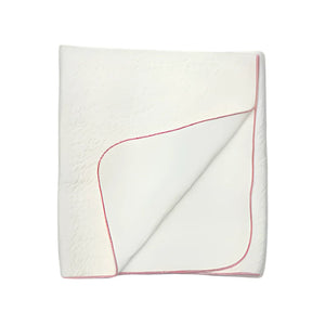 A front view of the Latte jacquard blanket in white with a mauve edge.
