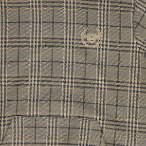 A high-resolution close-up of the soft cotton fabric texture and plaid print pattern.