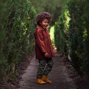 A high-resolution close-up of the cotton corduroy texture and warm rosewood color.