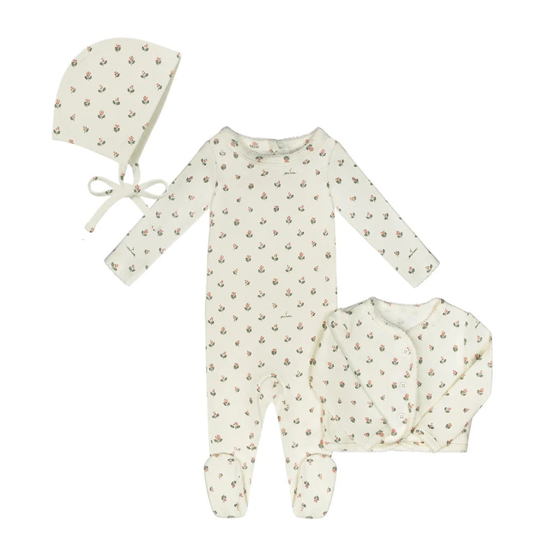 A breathtaking Little Parni Floral Cardigan Layette Set and Bonnet, showcasing its authoritative architectural fit and refined botanical print for an elegant newborn wardrobe.
