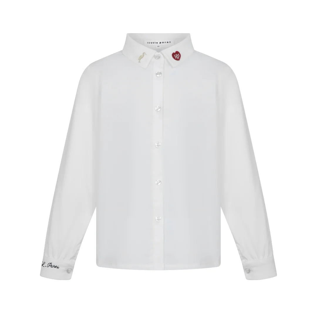 A front view of the Little Parni girl's elegant embroidered shirt in white.