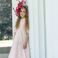A child wearing the Little Tempest pink taffeta gown at a formal celebration.