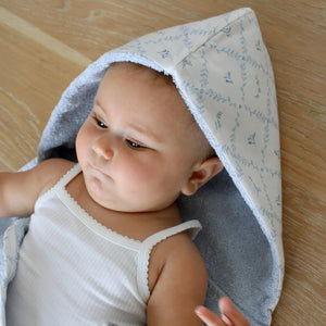 A detailed view of the hood on the blue Little Threads bath towel.