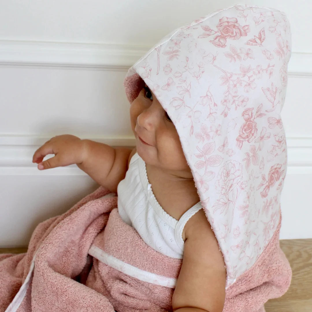 A close-up focus on the absorbent fabric texture and the delicate toile design.
