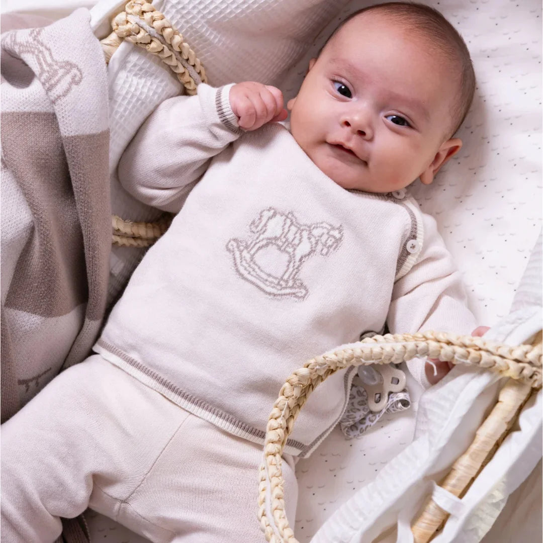 A newborn baby resting comfortably in the Livly Rocking Horse Envelop Set.