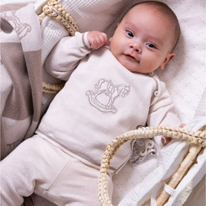 A newborn baby resting comfortably in the Livly Rocking Horse Envelop Set.