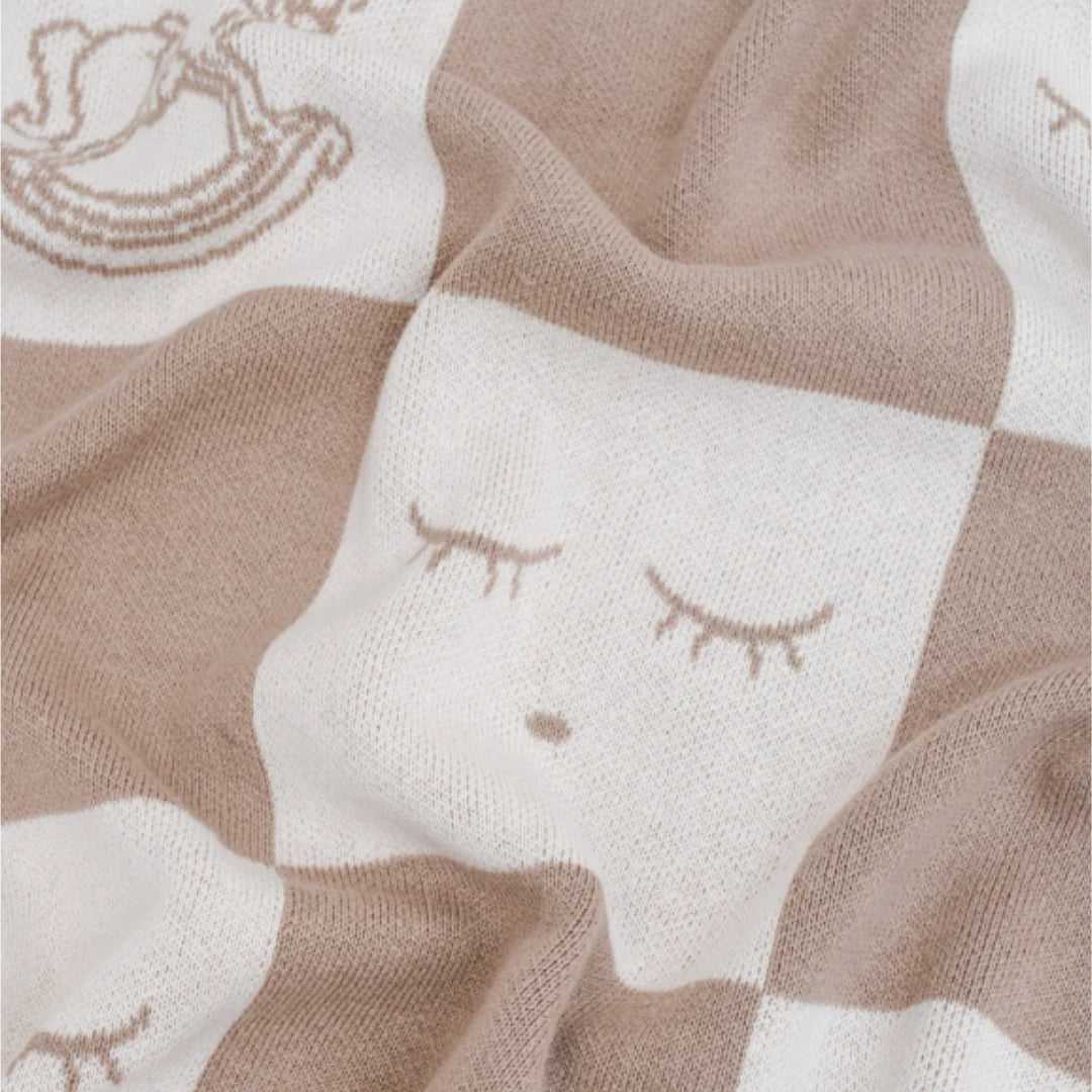A high-resolution close-up of the delicate knit texture and the Rocking Horse motif.