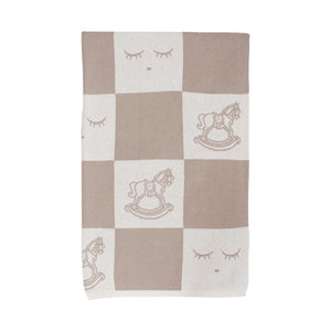 A front view of the Livly Rocking Horse Knitted Blanket in White Sand.